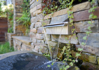 Stainless steel scupper and basalt spill basin.