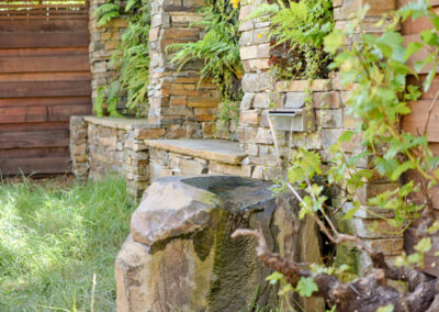 Green wall and boulder