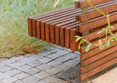 Basalt split-cube cobbles and custom redwood bench.